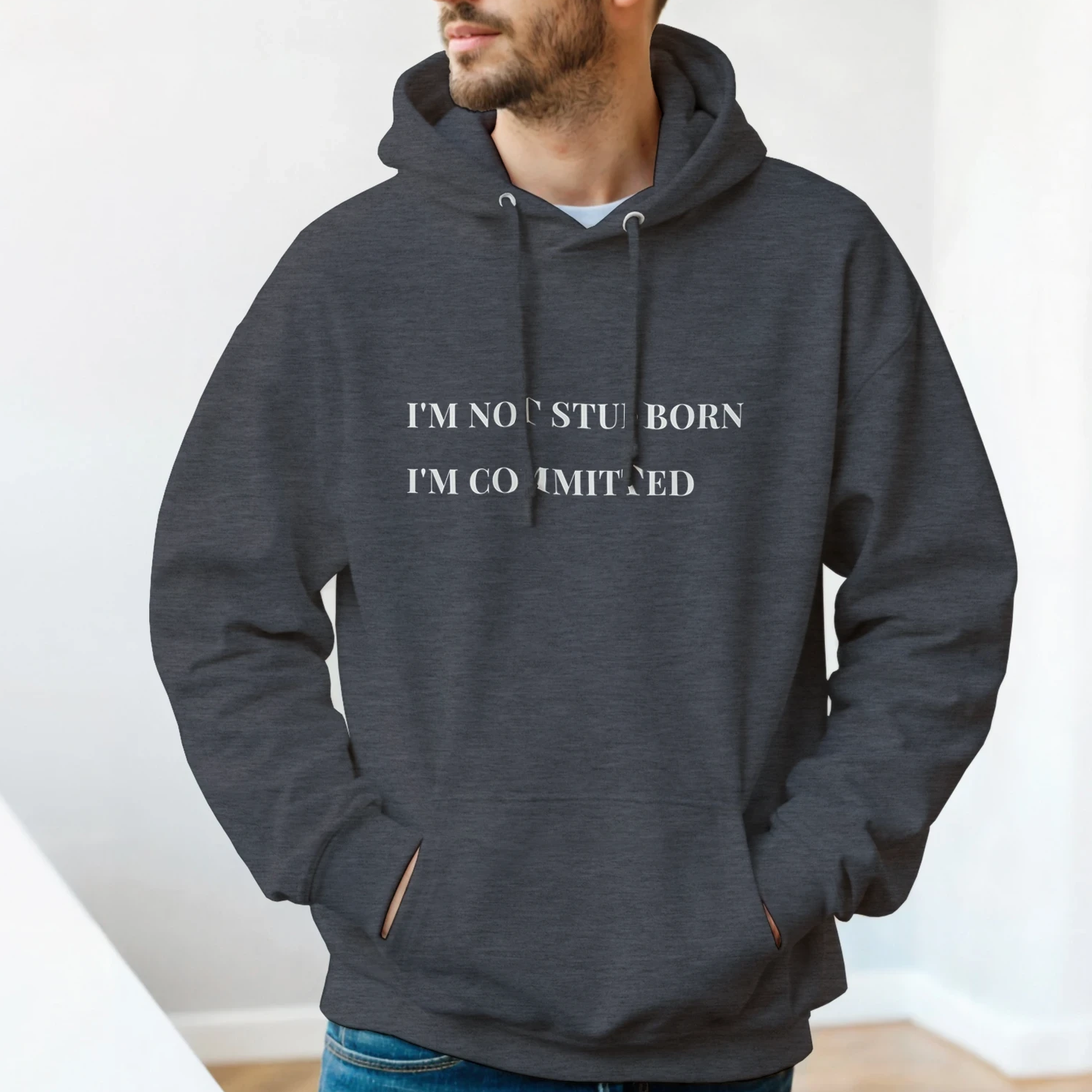Unisex "I'm Not Stubborn, I'm Committed" hoodie worn by model, cozy fit with ribbed cuffs and kangaroo pocket, casual sweatshirt for funny sarcastic style
