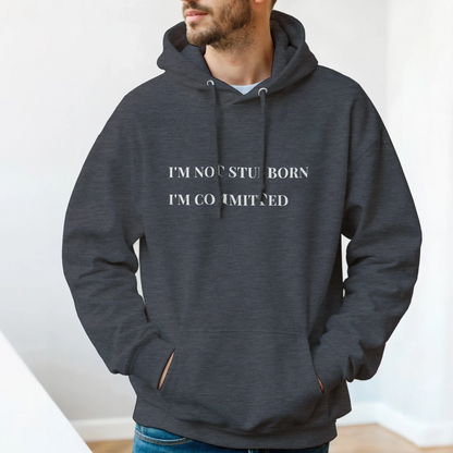 Unisex "I'm Not Stubborn, I'm Committed" hoodie worn by model, cozy fit with ribbed cuffs and kangaroo pocket, casual sweatshirt for funny sarcastic style