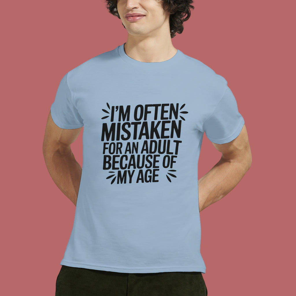 Person wearing a light blue t-shirt that says "I'm often mistaken for an adult because of my age" on a white background