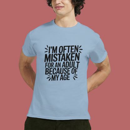 Person wearing a light blue t-shirt that says "I'm often mistaken for an adult because of my age" on a white background