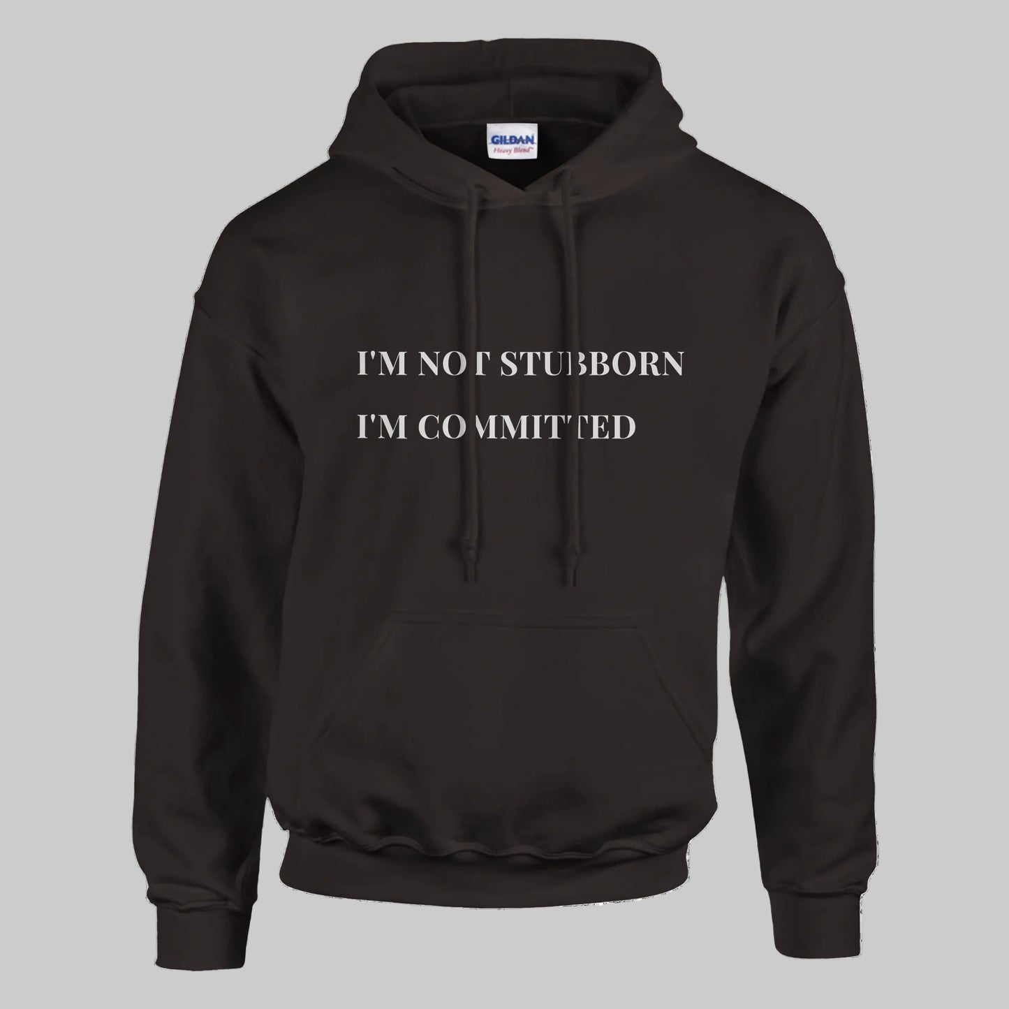 Unisex "I'm Not Stubborn, I'm Committed" hoodie worn by model, cozy fit with ribbed cuffs and kangaroo pocket, casual sweatshirt for funny sarcastic style
