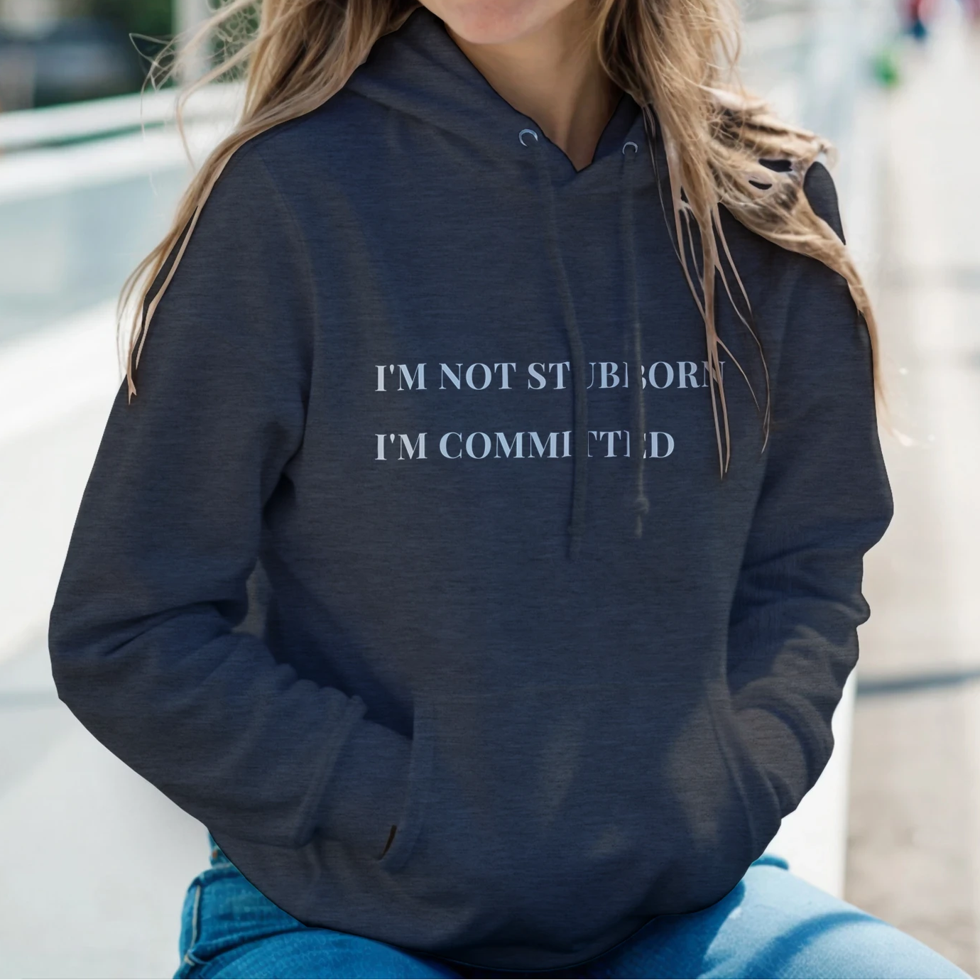 Unisex "I'm Not Stubborn, I'm Committed" hoodie worn by model, cozy fit with ribbed cuffs and kangaroo pocket, casual sweatshirt for funny sarcastic style